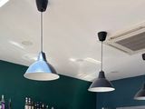 three lights hanging from the ceiling above a bar
