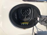 a white car with an electric charger attached to it
