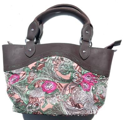 pink and green paisley print purse with brown leather handles