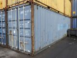 a blue and yellow shipping container sitting in a parking lot