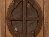 an old wooden window with a cross in the middle of it