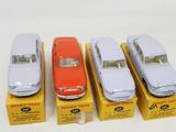four toy cars are lined up in a row next to each other