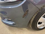 a close up of a car ' s front bumper with a hole in it