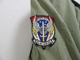 a military jacket with a patch on the back of it