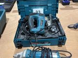 a blue tool box with a drill and other tools on a table