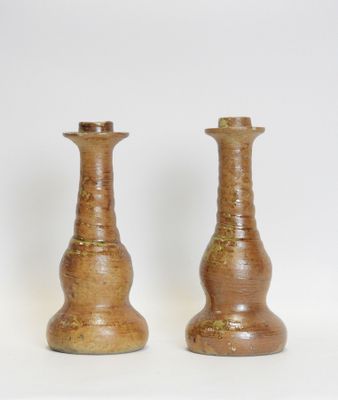 two vases that are sitting on a white surface
