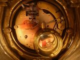 a gold clock with a clock face on it