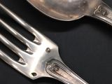 a fork and a spoon on a black table