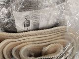 a lot of belts wrapped in plastic on a table