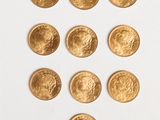 a lot of gold coins on a white surface