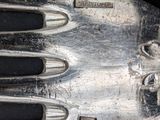 a close up of a silver fork on a black surface