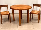 deux chaises en bois et une table dans une pièce