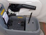a machine that is sitting on the ground next to a white sheet