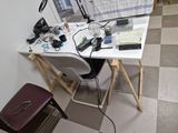a desk with a chair and a laptop on it