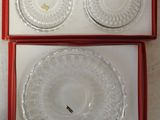 two clear glass plates in a red box on a white surface