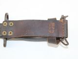 a brown leather belt with a metal buckle on it