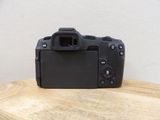 a camera sitting on a wooden table with a white wall in the background