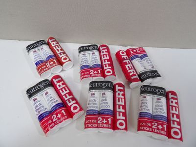 several tubes of toothpaste sitting on top of a white table