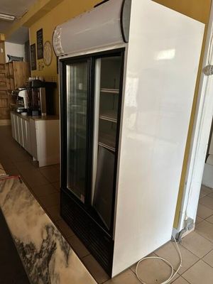 a refrigerator in the middle of a kitchen with a marble counter top