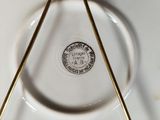 a close up of a white plate with a triangle on it