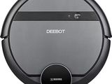 a close up of a robotic vacuum cleaner on a white surface