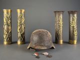 three vases and a helmet sitting on a table