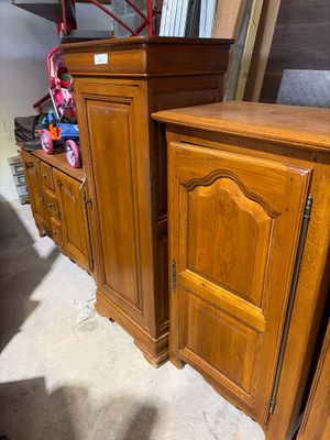 two wooden cabinets in the corner of a room