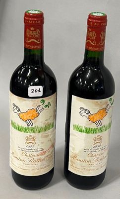 two bottles of wine sitting next to each other on a table