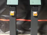 two electronic stands that are sitting on the floor