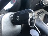 a car key that is attached to the steering wheel of a car