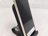 a cell phone that is on a stand on a table