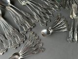 a lot of silver spoons and spoon spoons on a table