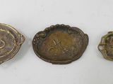 three antique brass buttons, one with a lion and the other with a lion