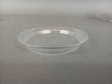 a clear bowl sitting on a table in the middle of the room