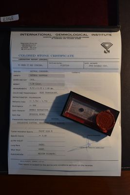 a piece of paper with a stamp on it next to a calculator