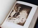 an open book with a black and white photo of a man on a horse