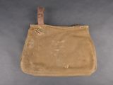 an old canvas bag with a leather handle on a gray background