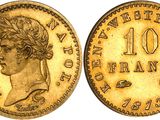 a gold coin with a woman ' s head and a crown on it