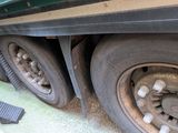 a close up of a flat tire on a green truck