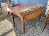 a wooden table with a drop leaf on top of it