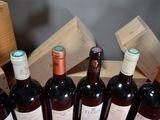 several bottles of wine are lined up in a row on a table