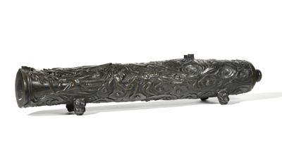 bronze figurine of a fish on a wooden stand on a white background