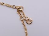 an image of a close up of a gold chain bracelet