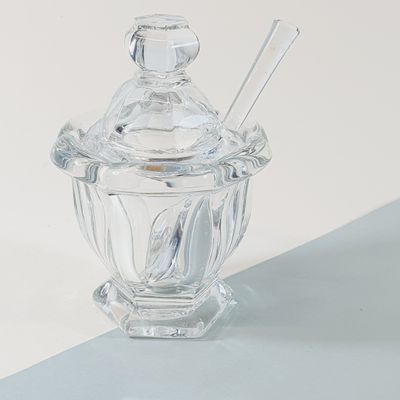 a clear glass jar with a spoon and a spoon in it