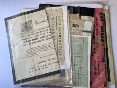 a lot of old papers on a white table