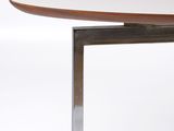 a close up of a table with a metal base and a white table top