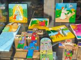 a glass display case filled with wooden toys and books