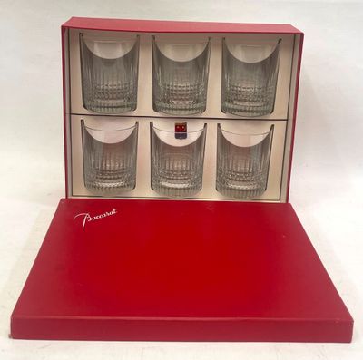 four shot glasses in a red box on a white background