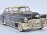 a black and gold toy car on a white surface