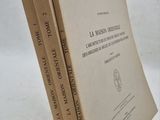 three books are stacked on top of each other on a white surface